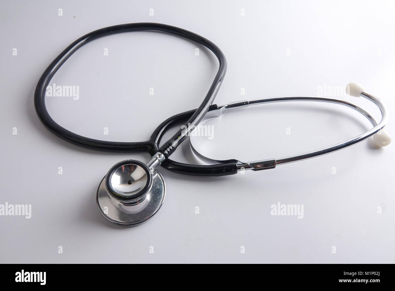 A black stethoscope isolated on white background Stock Photo - Alamy