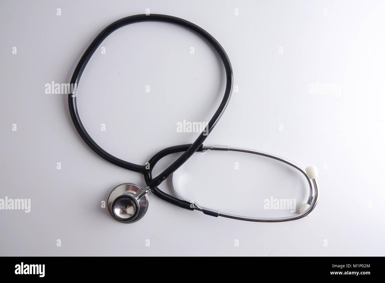 A black stethoscope isolated on white background Stock Photo - Alamy
