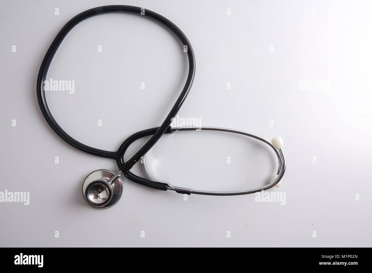 A black stethoscope isolated on white background Stock Photo - Alamy