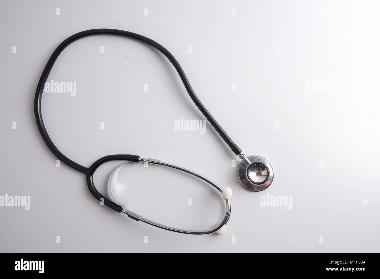 A black stethoscope isolated on white background Stock Photo - Alamy