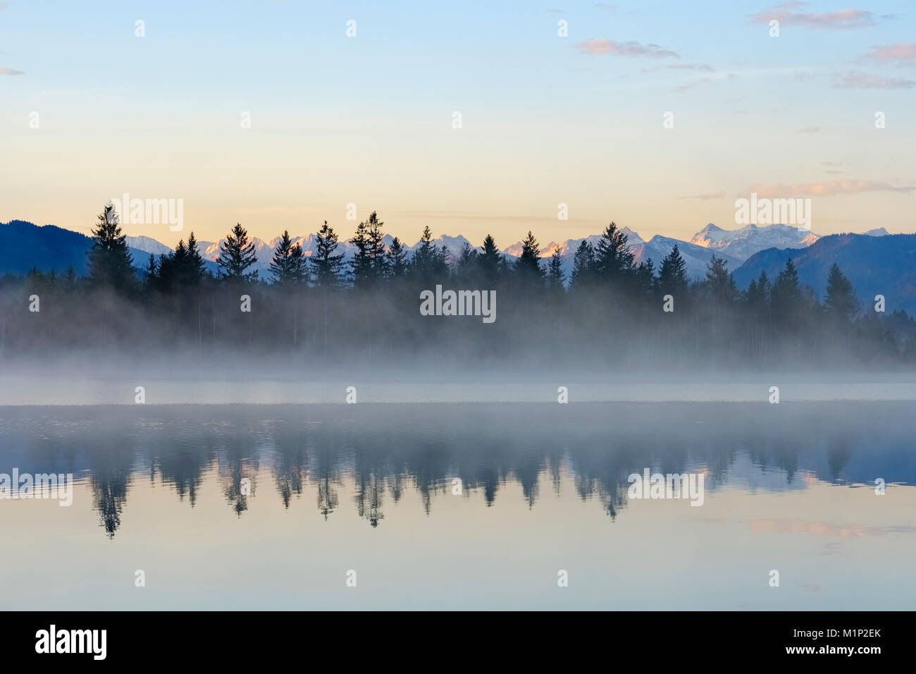 Morning atmosphere with early morning mist at Kirchsee,near Sachsenkam,alpine panorama with Karwendel Mountains,Upper Bavaria Stock Photo