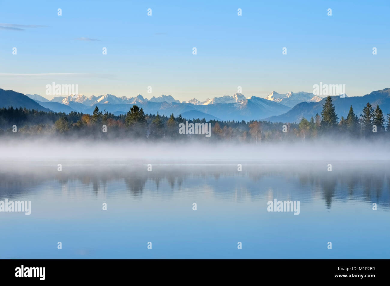 Autumn morning,with early morning fog at the Kirchsee,near Sachsenkam,alpine panorama with Karwendel Mountains,Upper Bavaria Stock Photo