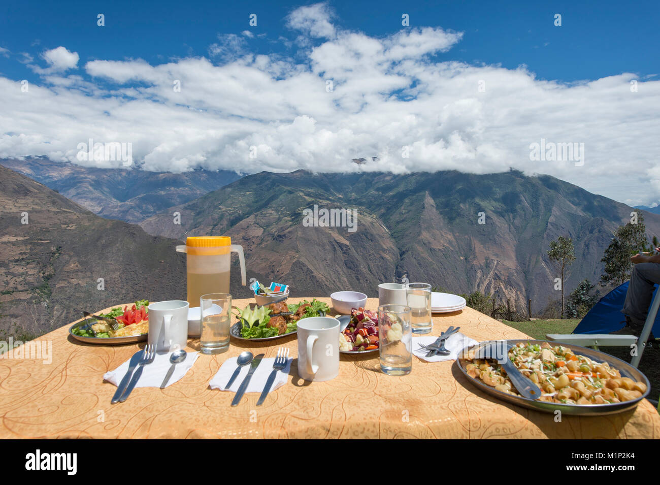 Covered table with dinner in front of mountain panorama,Choquequirao