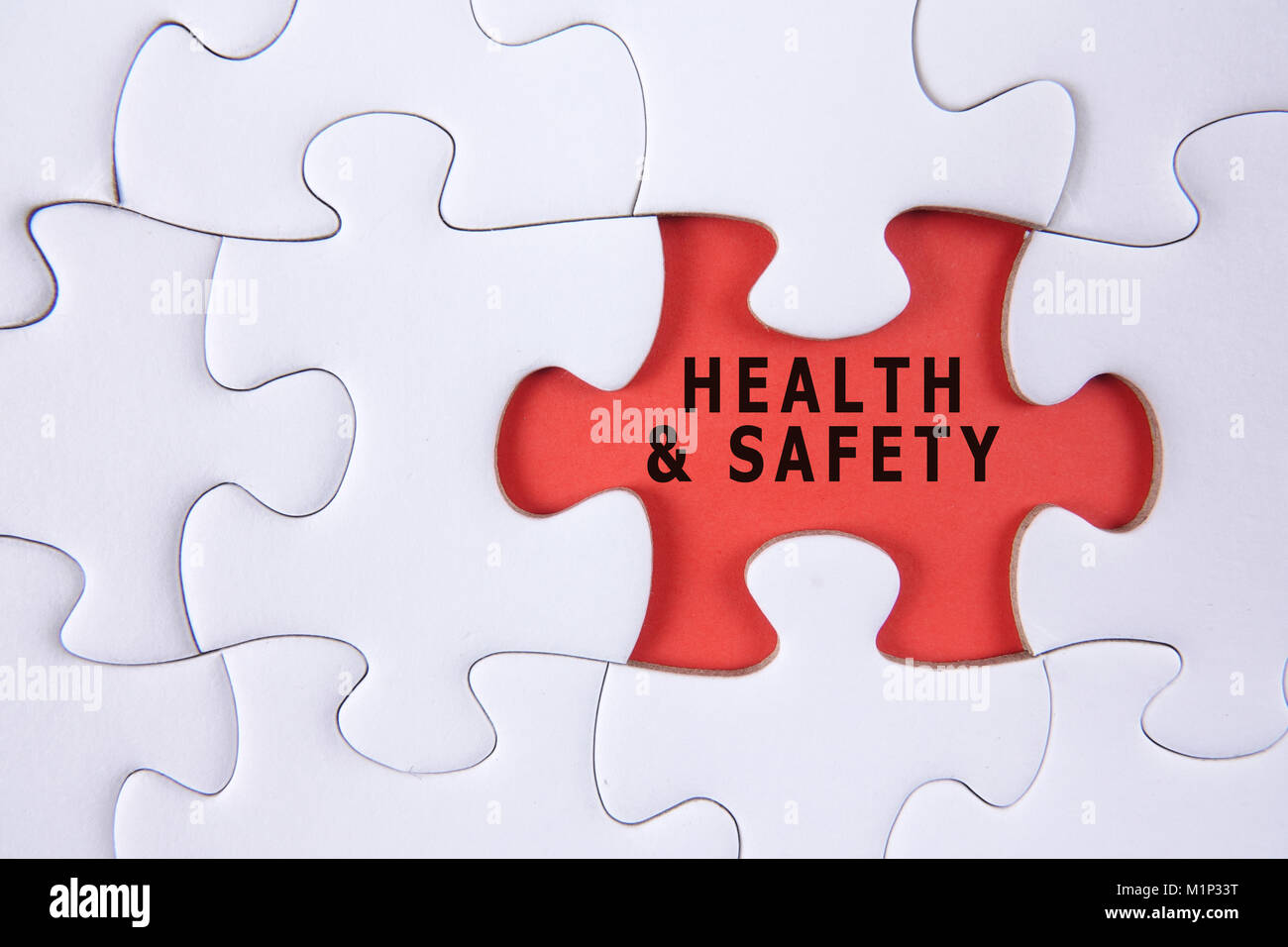 HEALTH AND SAFETY CONCEPT with white jigsaw puzzle Stock Photo Alamy