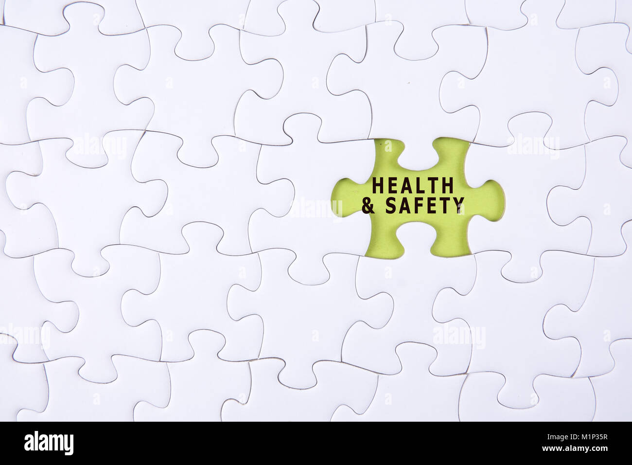 HEALTH AND SAFETY CONCEPT with white jigsaw puzzle Stock Photo Alamy