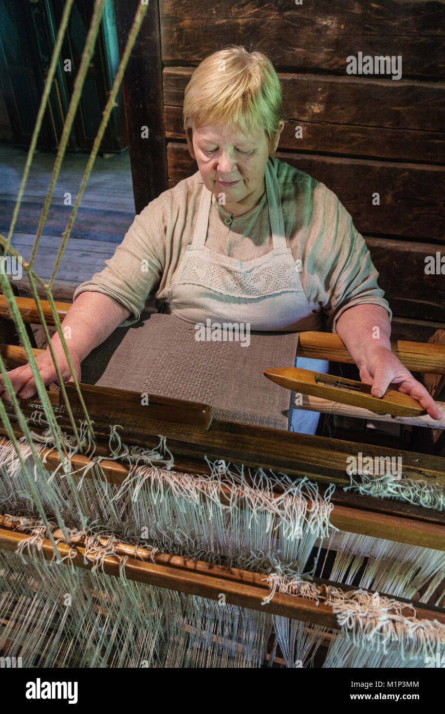 Weaver at work in 19th century house, Latvian Ethographic Open Air Museum, Riga, Latvia, Europe Stock Photo