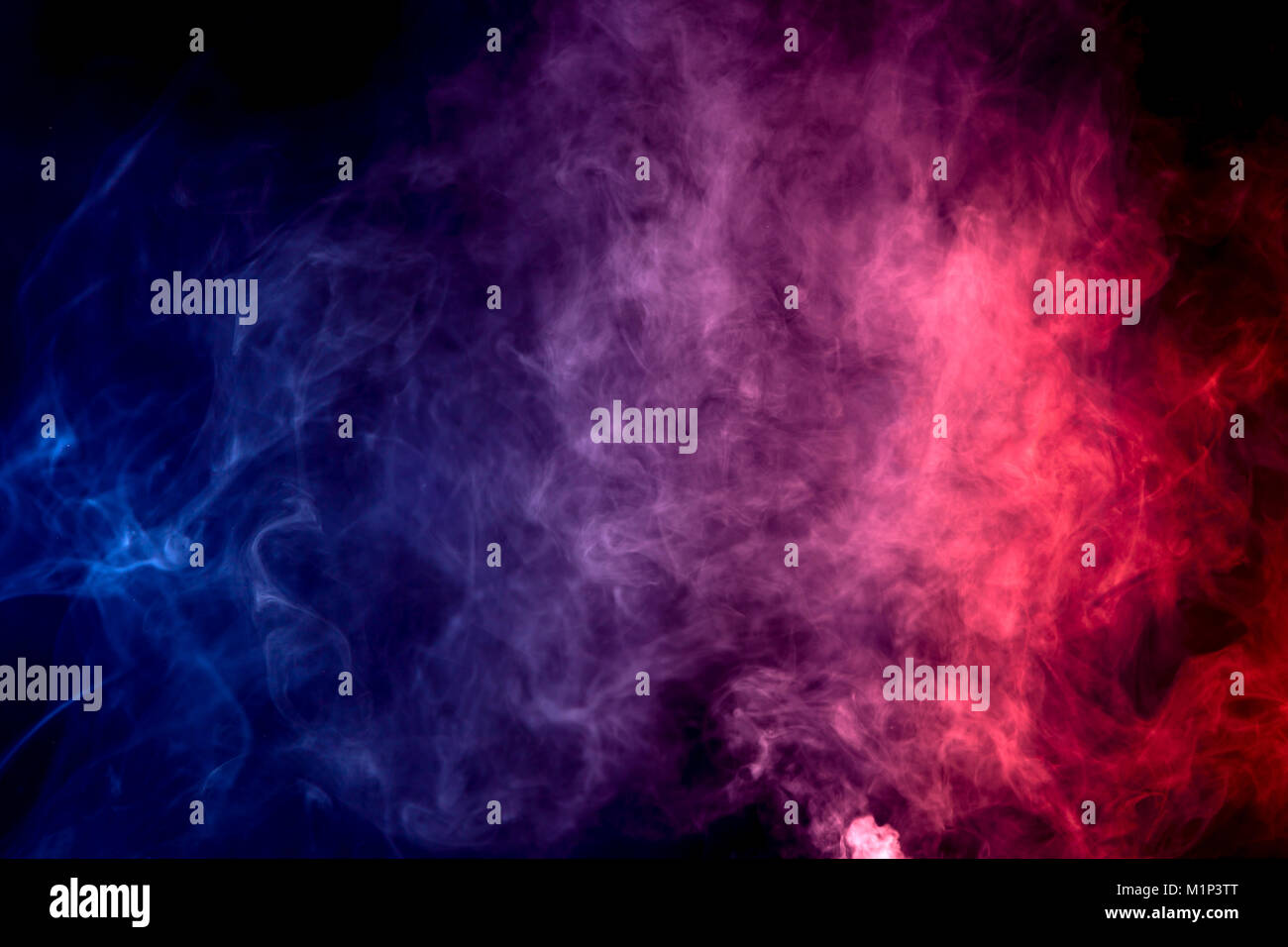 Colorful purple and blue smoke clouds on dark background Stock Photo