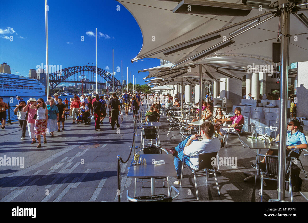 The Opera Quays boardwalk leading to Sydney Opera House at Circular Quay East along the Bennelong Apartments 'Toaster Building' promenade. Stock Photo