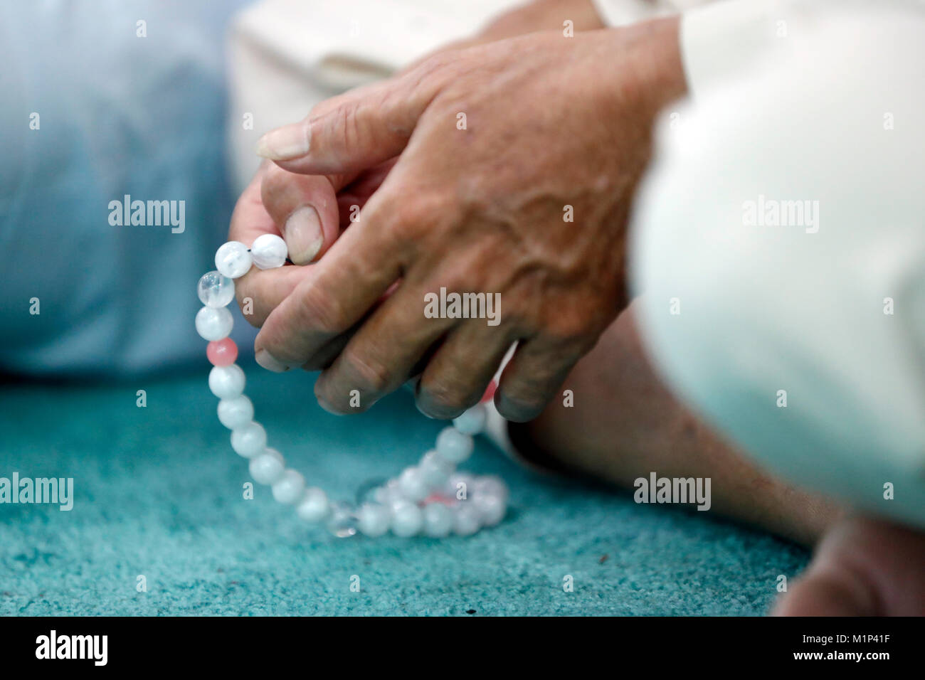 Close-up of man praying in a mosque with Tasbih (prayer beads), Masjid Al Rahim Mosque, Ho Chi Minh City, Vietnam, Indochina, Southeast Asia, Asia Stock Photo