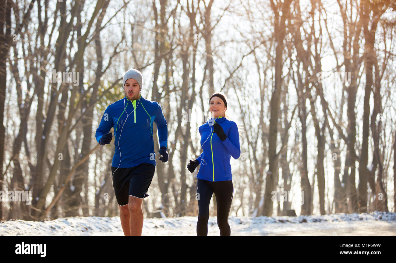 Male and female jogging in nature Stock Photo - Alamy