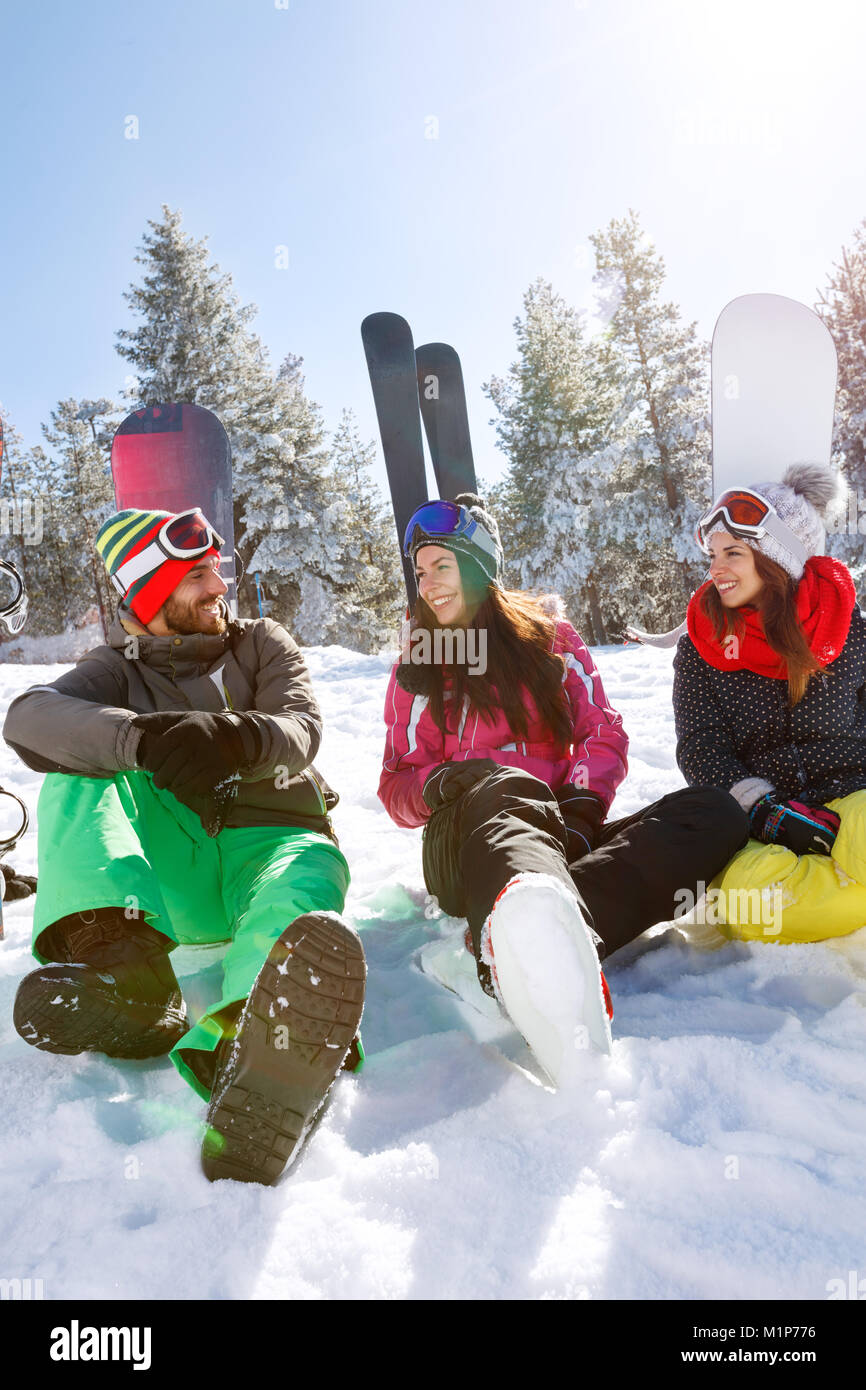 Young skiers having break on snow in nature Stock Photo