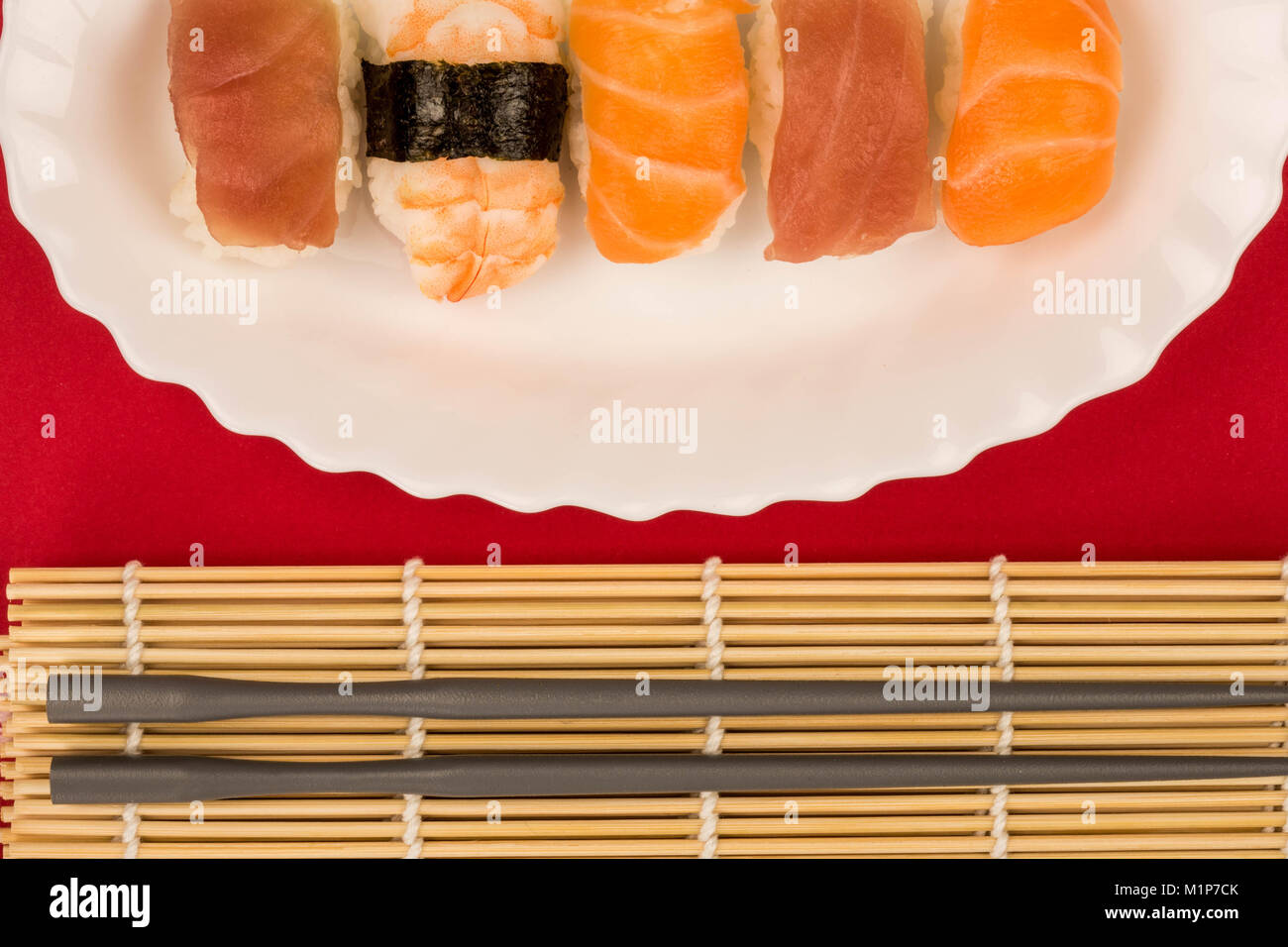 Japanese Style Prawn Salmon And Tuna Nigiri Sushi Against A Red Background Stock Photo