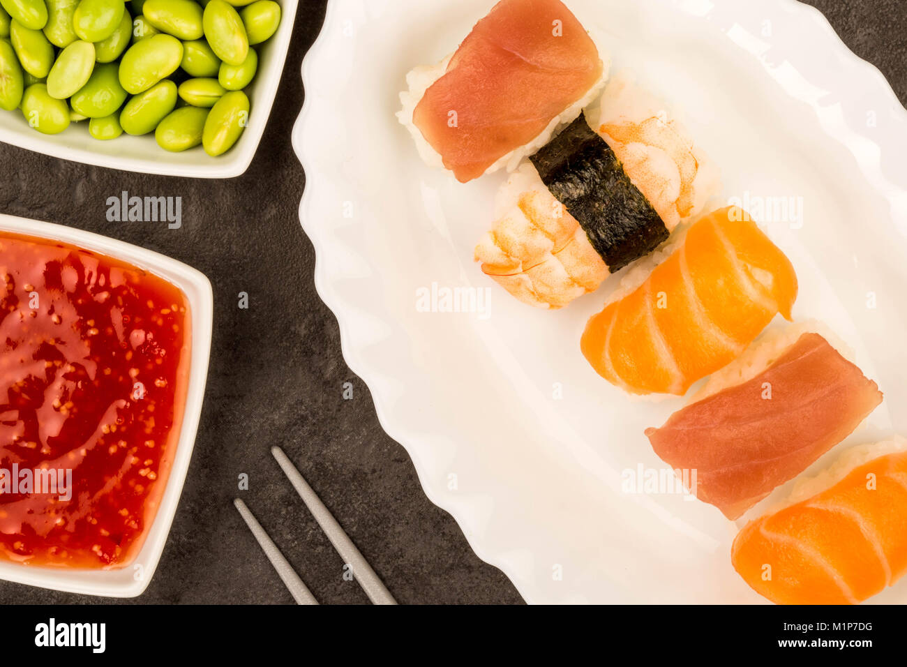 Japanese Style Prawn Salmon And Tuna Nigiri Sushi Against A Black Background Stock Photo