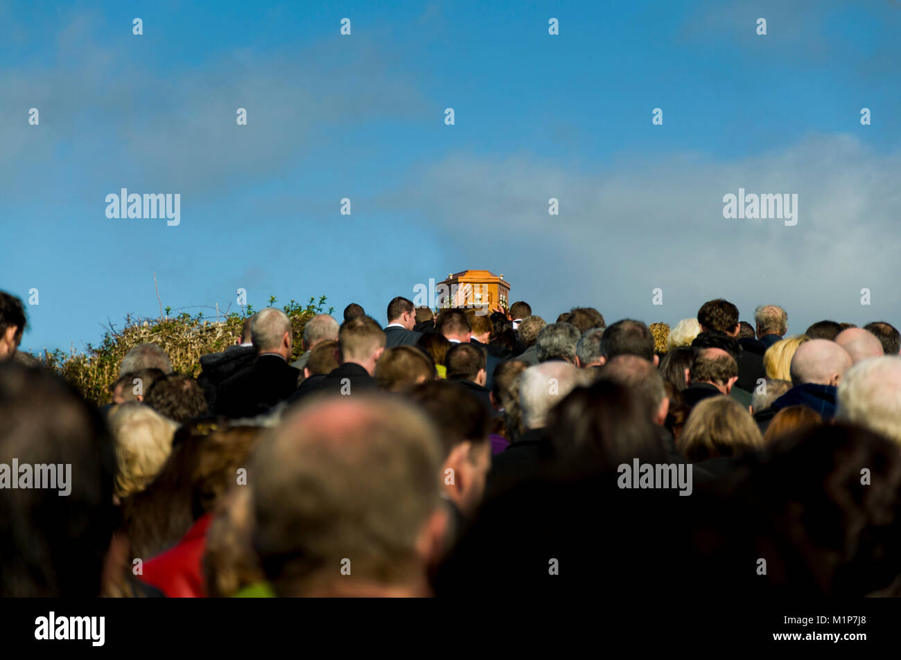 Funeral procession mourners follow the coffin in rural Ireland Stock Photo
