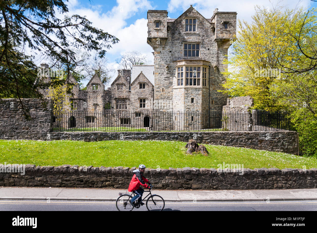 Donegal Castle and cyclist by River Eske, Donegal Town, Ireland Stock Photo