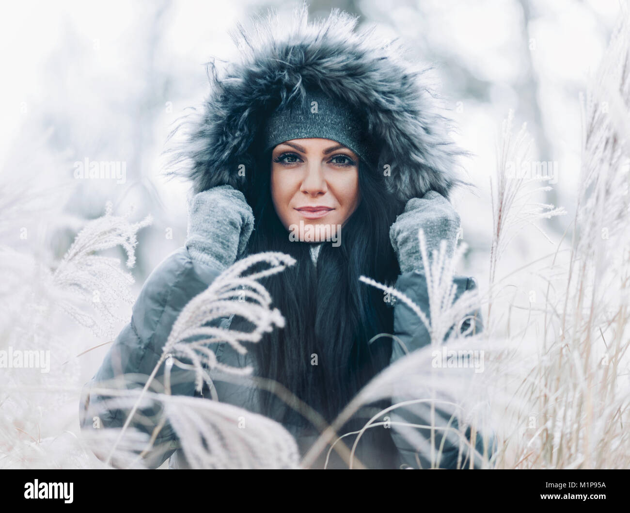 Beautiful young woman wearing a fur hood winter coat Stock Photo - Alamy