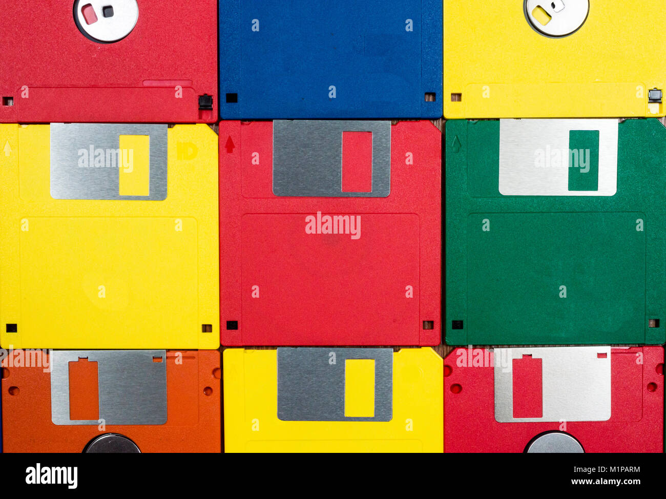 Horizontal close-up shot of nine multicolored plastic diskettes.  Shows fronts and backs of disks. Stock Photo