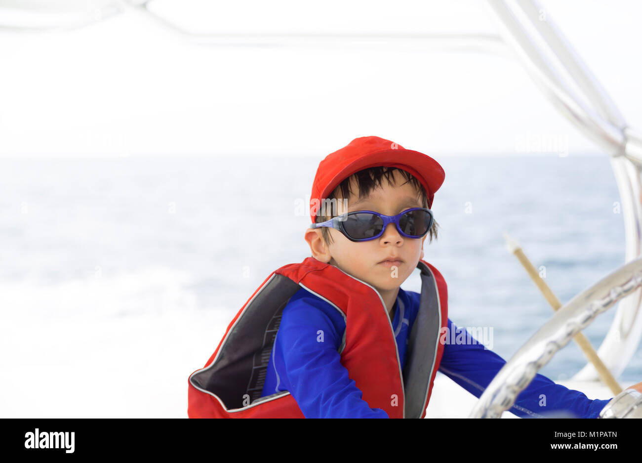 Boy driving boat hi-res stock photography and images - Alamy