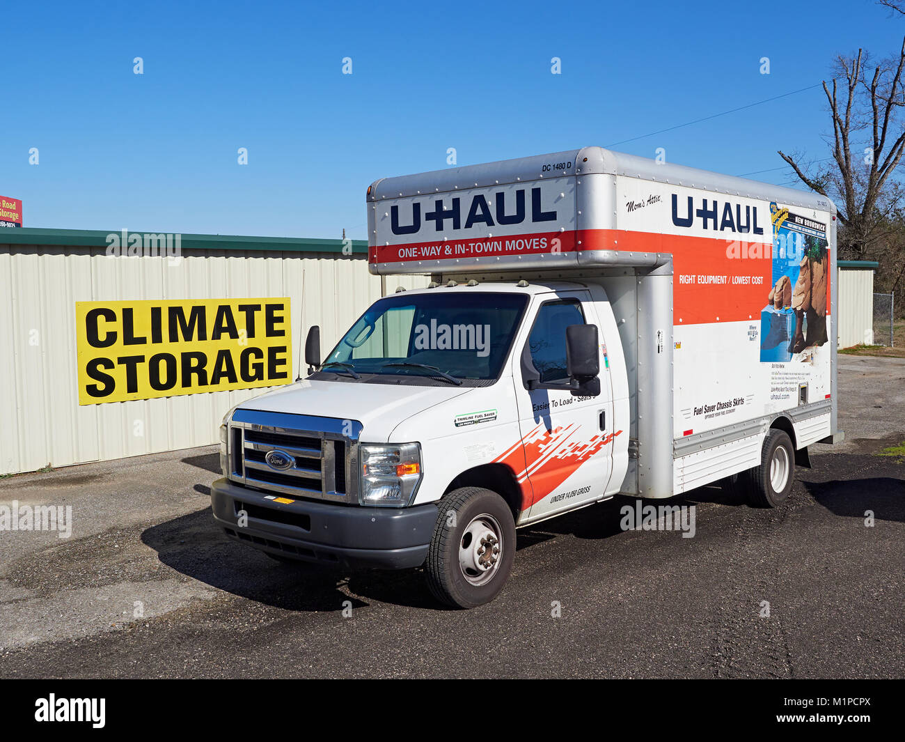 Uhaul truck sits parked next to a self storage or climate storage unit facility in Montgomery Alabama, United States. Stock Photo