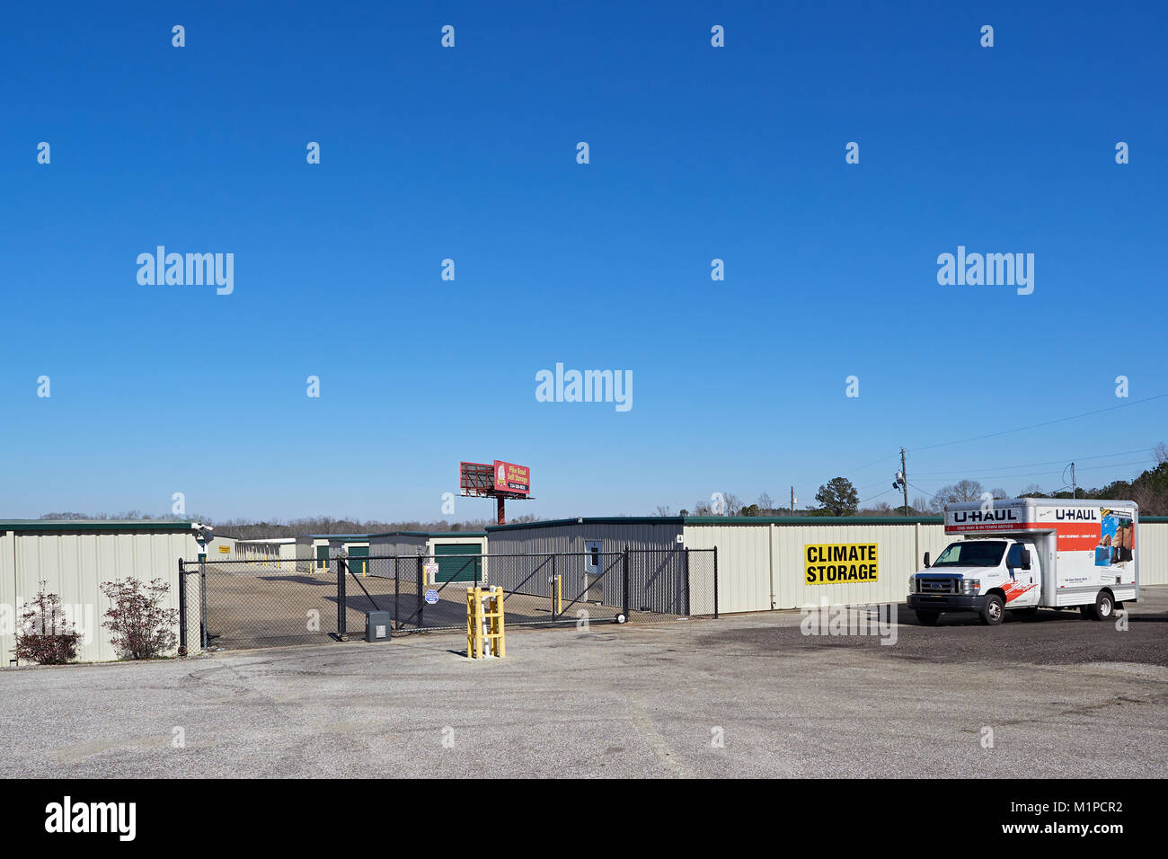 Exterior front entrance gate to a self storage facility that is climate controlled and rents UHAUL trucks in Montgomery Alabama United States. Stock Photo