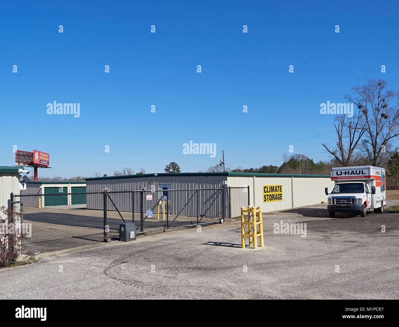 Exterior front entrance gate to a self storage facility that is climate controlled and rents UHAUL trucks in Montgomery Alabama United States. Stock Photo