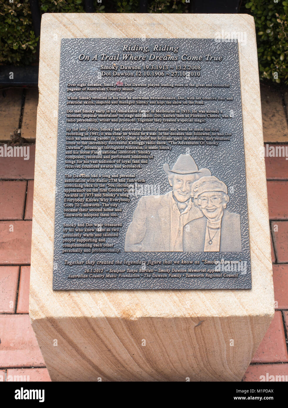 Bronze plaque mounted on a sandstone block commemorating Smoky Dawson