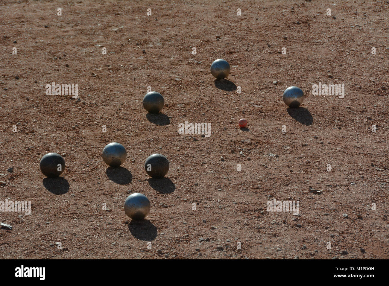 boules balls around the jack or boccino on a gravel court in the south