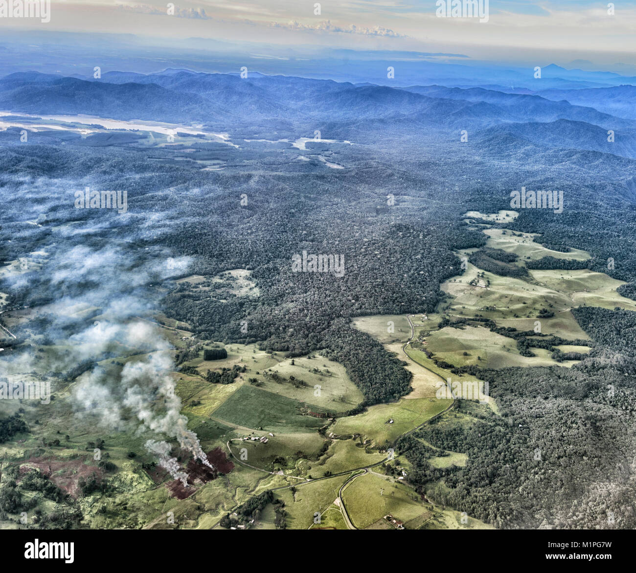 Crops burning in a deforested area in the coastal range near Cairns, Far North Queensland, FNQ, QLD, Australia Stock Photo