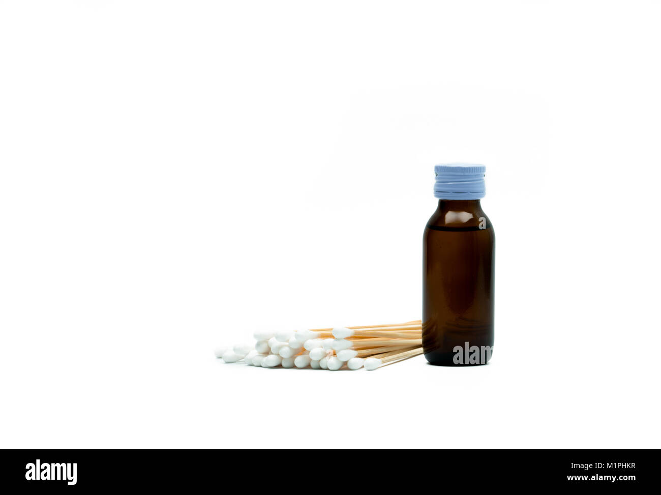 Cotton sticks and antiseptic solutions in amber glass bottle isolated on white background