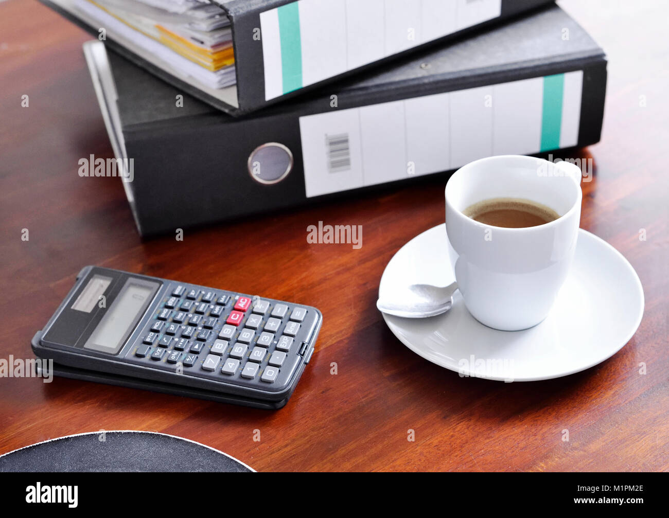 Working place or work place scene with office supply and coffee cup. Coffee break, office scene. Business background with cup of coffee, calculator. Stock Photo