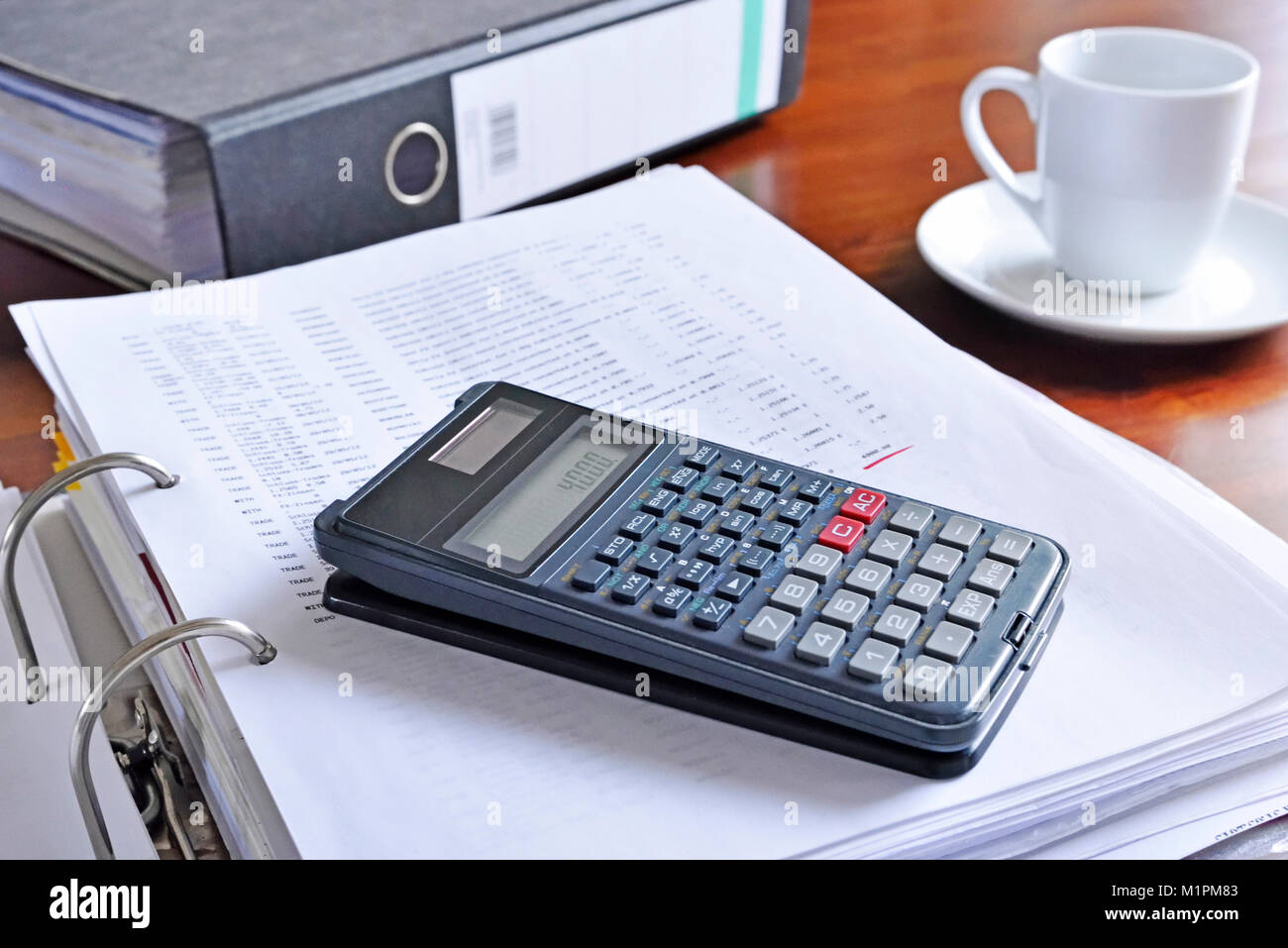 Working place or work place scene with office supply and coffee cup. Coffee break, office scene. Business background with cup of coffee, calculator. Stock Photo