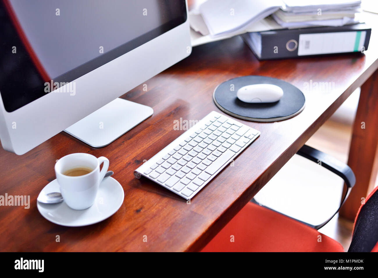 Working place scene or office scene with cup of coffee and computer. Workplace, coffee break, business scene with files and coffee. Stock Photo