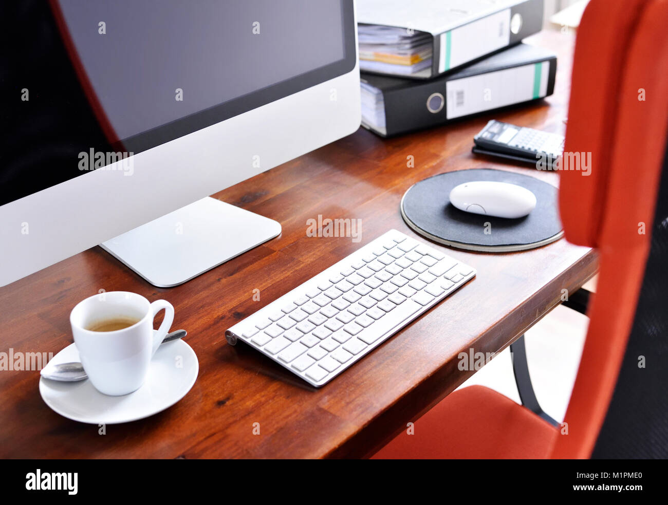 Working place scene or office scene with cup of coffee and computer. Workplace, coffee break, business scene with files and coffee. Stock Photo