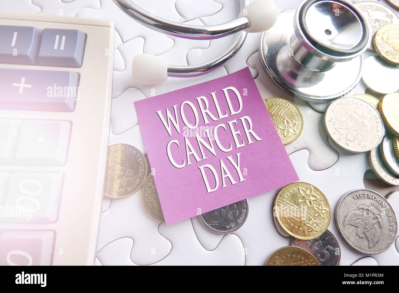 WORLD CANCER DAY CONCEPT; Stethoscope,jigsaw puzzle  and sticker. Stock Photo