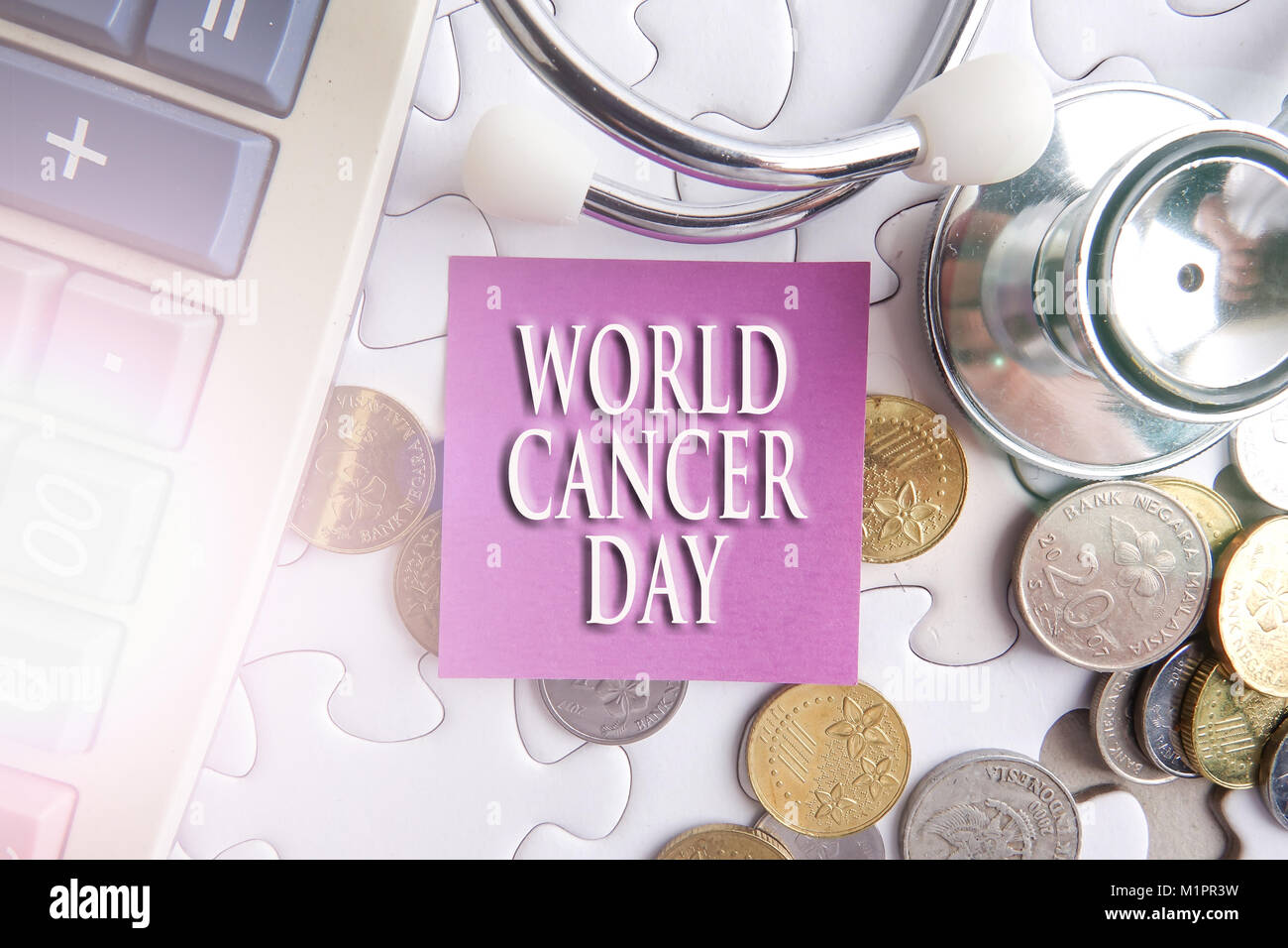 WORLD CANCER DAY CONCEPT; Stethoscope,jigsaw puzzle  and sticker. Stock Photo