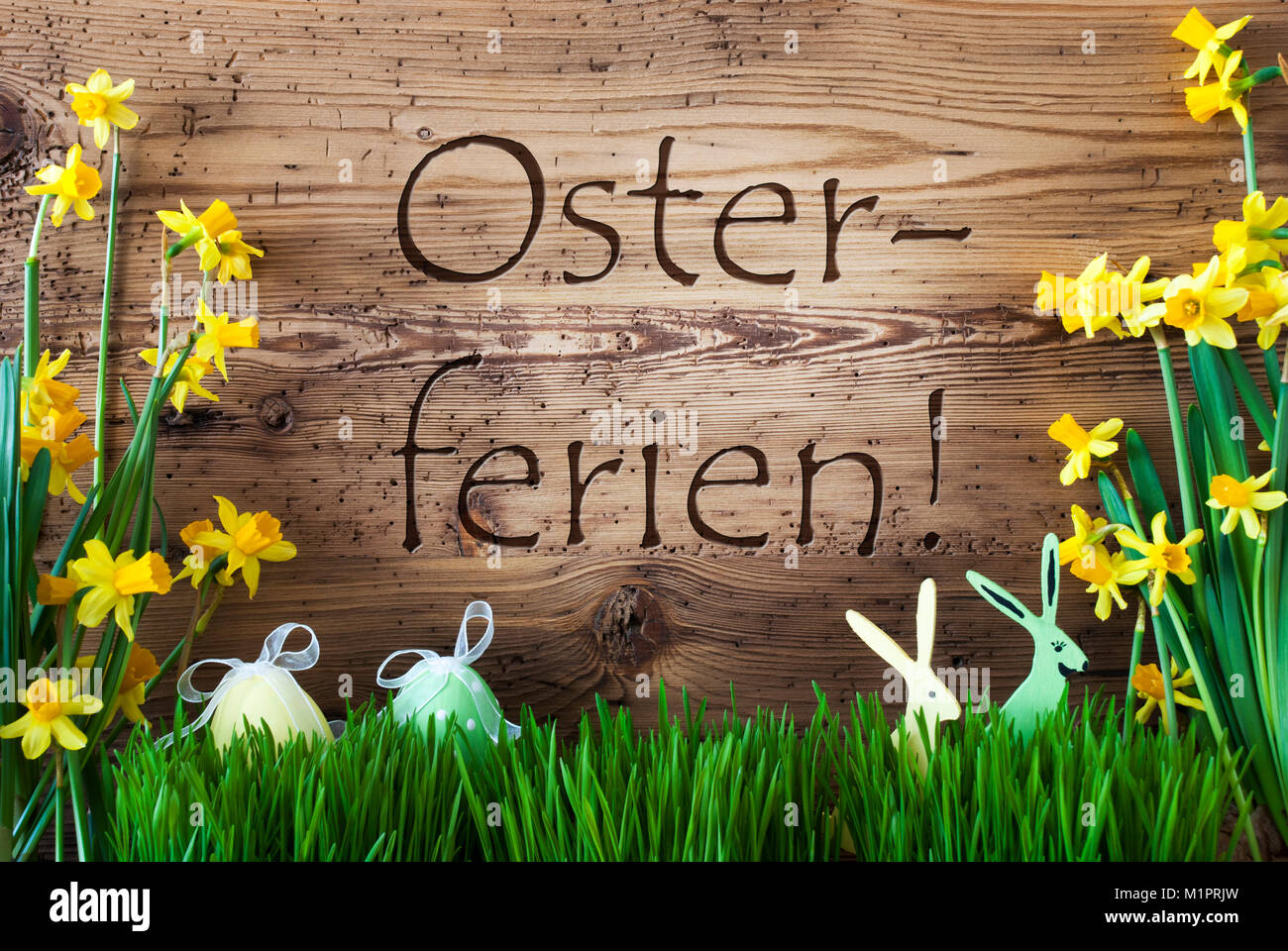 Wooden Background With German Text Osterferien Means Easter Holidays.  Easter Decoration Like Easter Eggs And Easter Bunny. Sunny Yellow Spring  Flower Narcisssus With Gras. Card For Seasons Greetings Stock Photo - Alamy