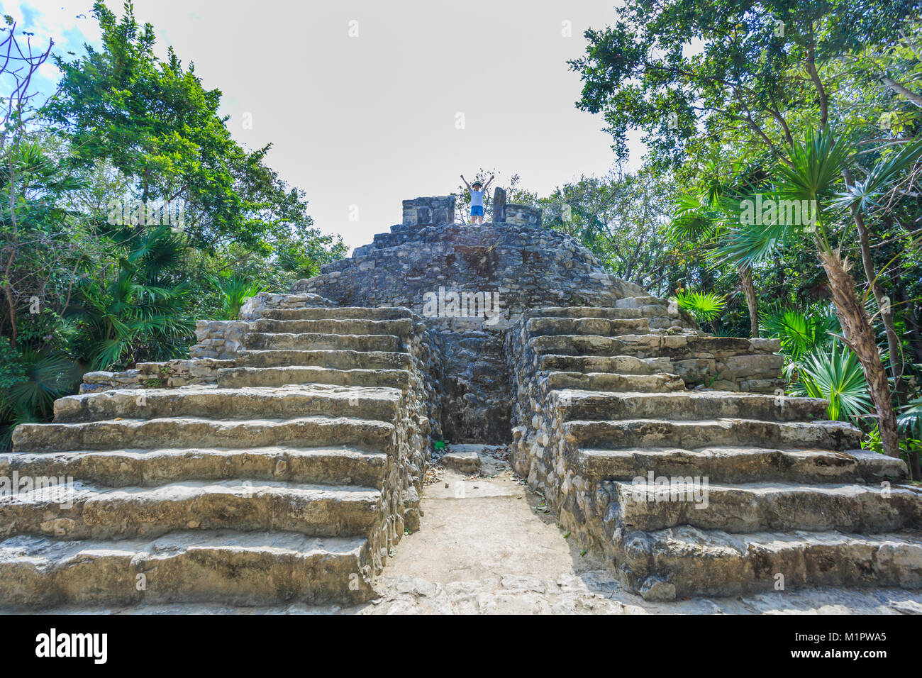 Kid standing on the top of antique ruins Stock Photo