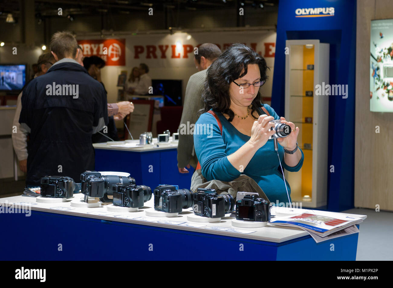 A woman looks at a camera she wants to buy, Stockholm, Sweden. Stock Photo