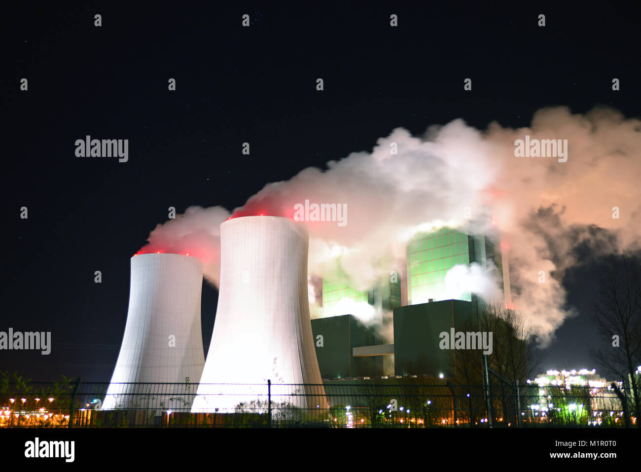 smoking chimneys of a lignite power plant at night Stock Photo - Alamy