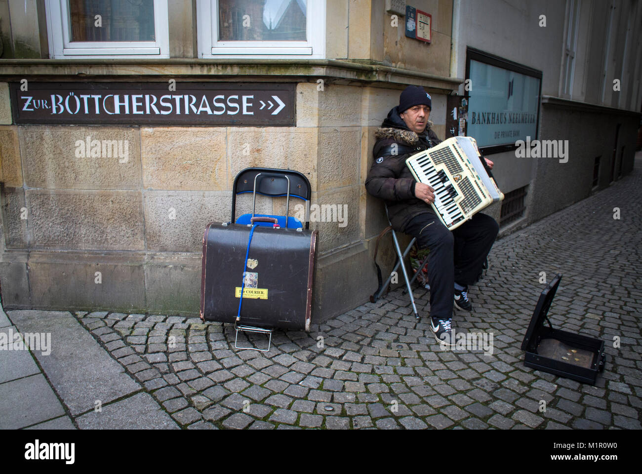 A busker plays at the entrance to the Böttcherstraße Bremen, Germany. Stock Photo