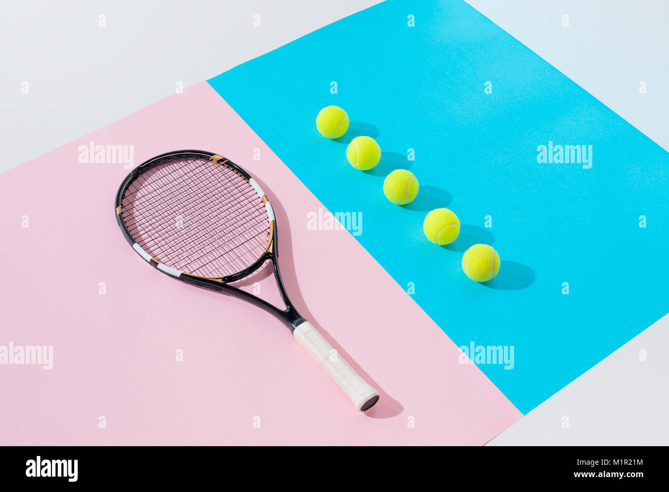 tennis racket on pink and yellow balls in row on blue Stock Photo - Alamy