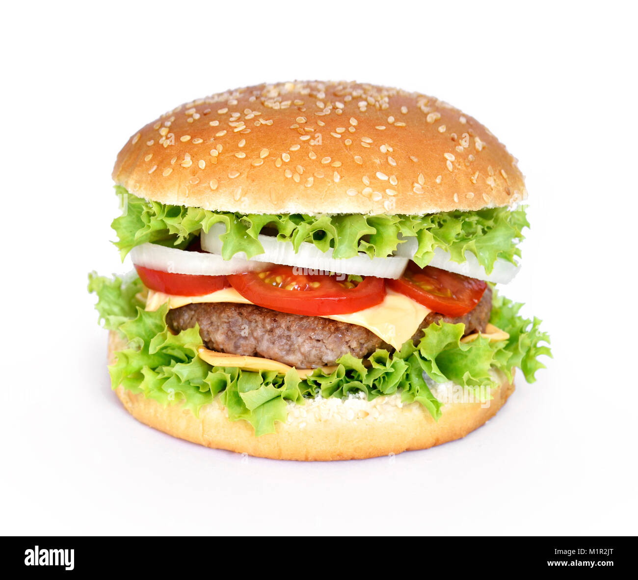 Delicious burger, hamburger or cheeseburger with fresh salad, tomatoes and onions. Gourmet burger with beef patty, isolated on white background. Stock Photo