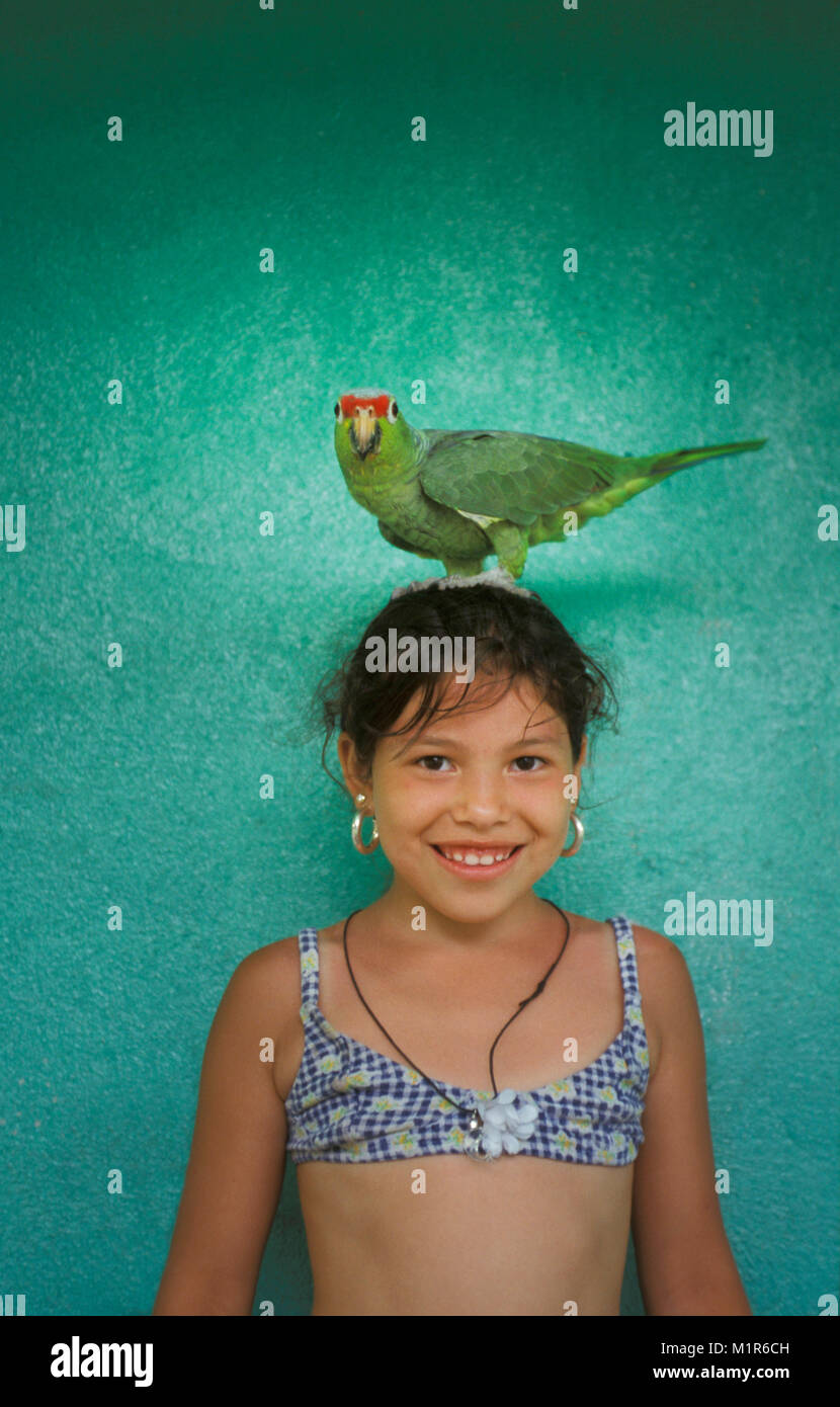 Costa Rica. Fortuna. Girl and parrot on head. Stock Photo
