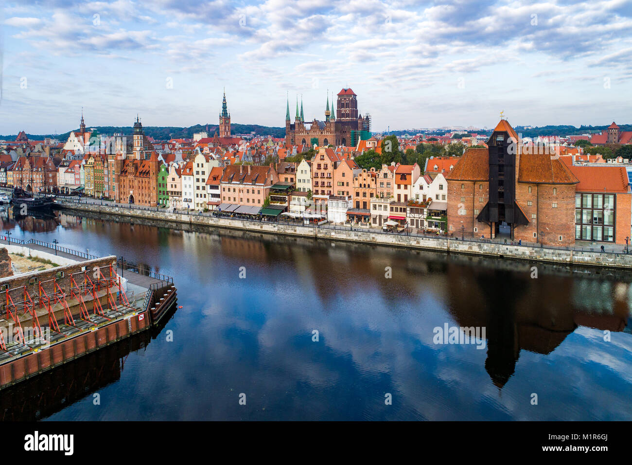 Gdansk old city in Poland with the oldest medieval port crane (Zuraw) in Europe, St Mary church, Town hall tower and Motlawa River. Aerial view. Stock Photo