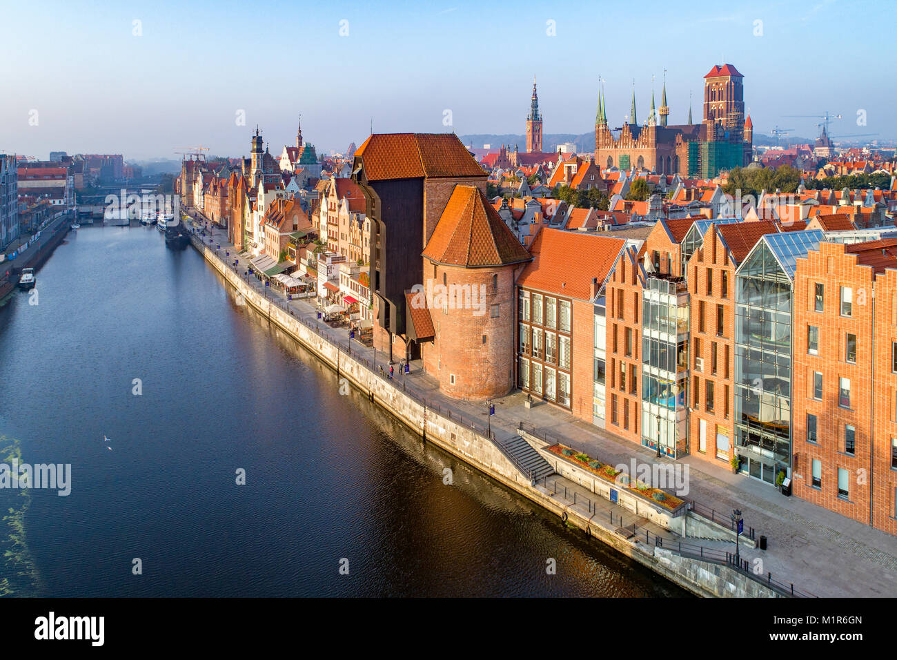 Gdansk old city in Poland with the oldest medieval port crane (Zuraw) in Europe, St Mary church, Town hall tower, Motlawa River and bridges. Aerial vi Stock Photo