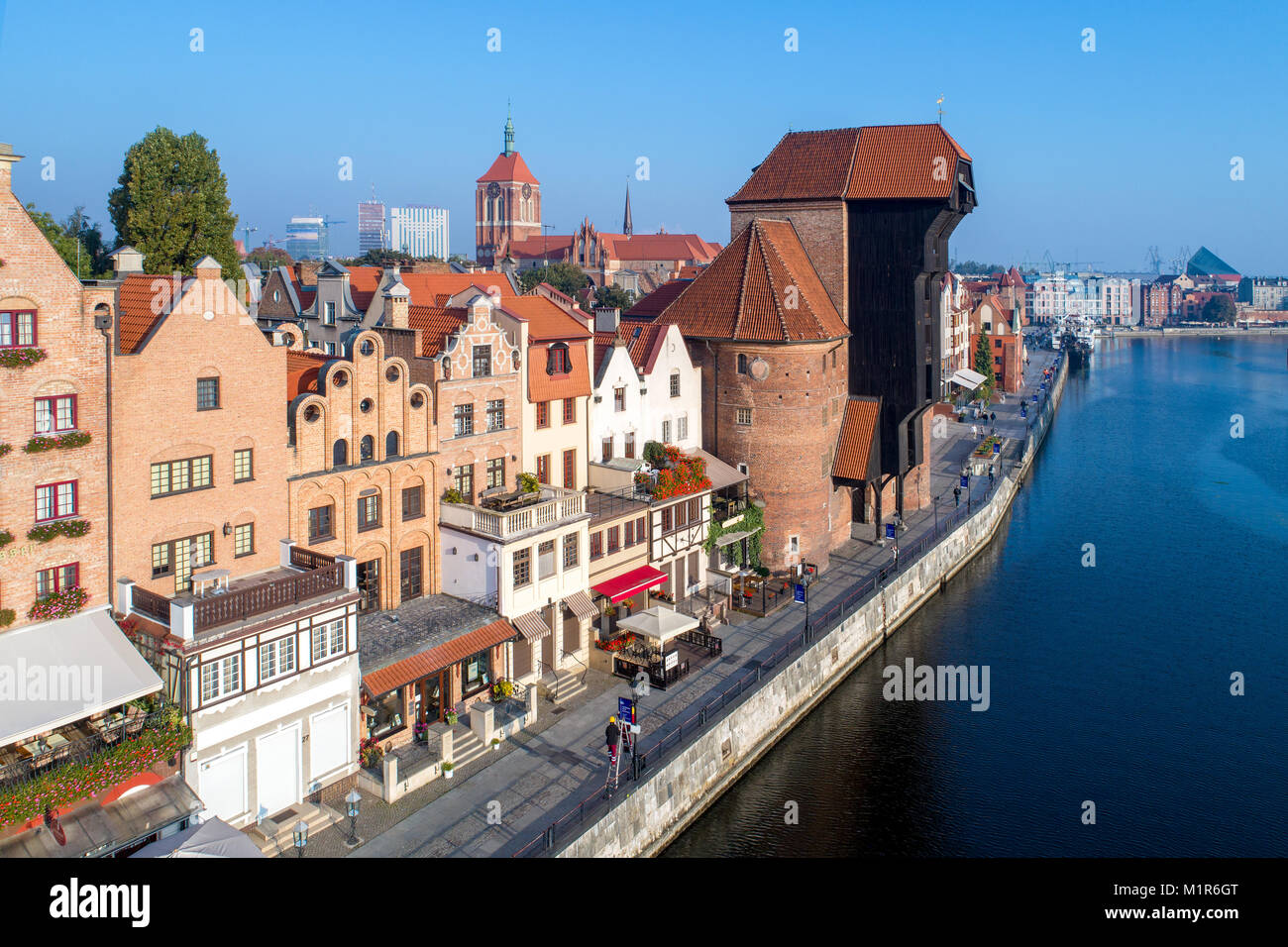 Gdansk old city in Poland with the oldest medieval port crane (Zuraw) in  Europe, St John church and Motlawa River with embankment and promenade.  Aeria Stock Photo - Alamy