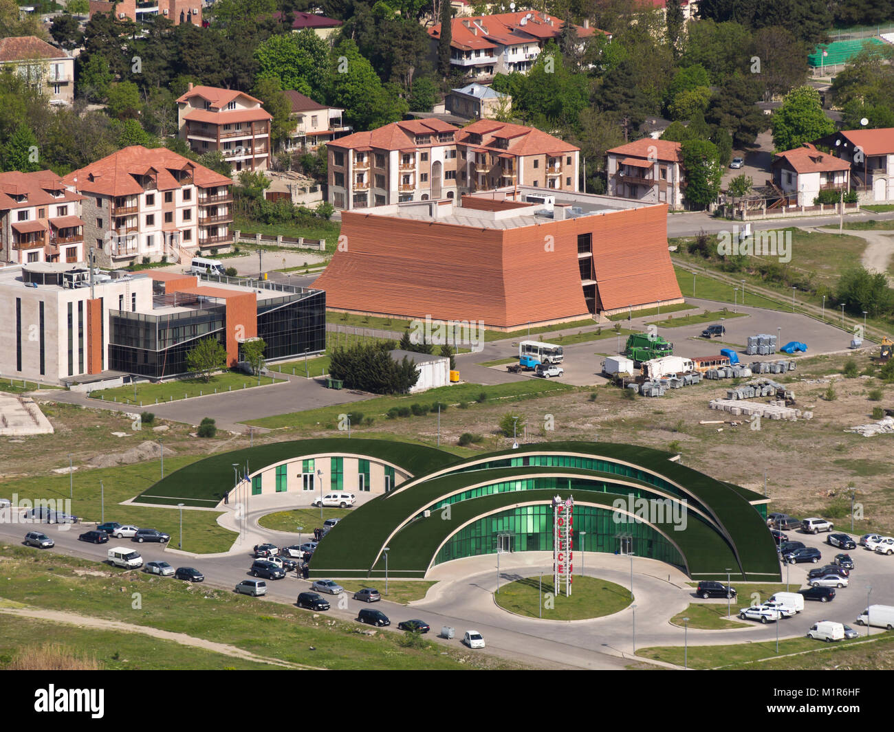 Modern architecture in Mtskheta Georgia, police station in green glass to highlight transparency, local government building behind Stock Photo