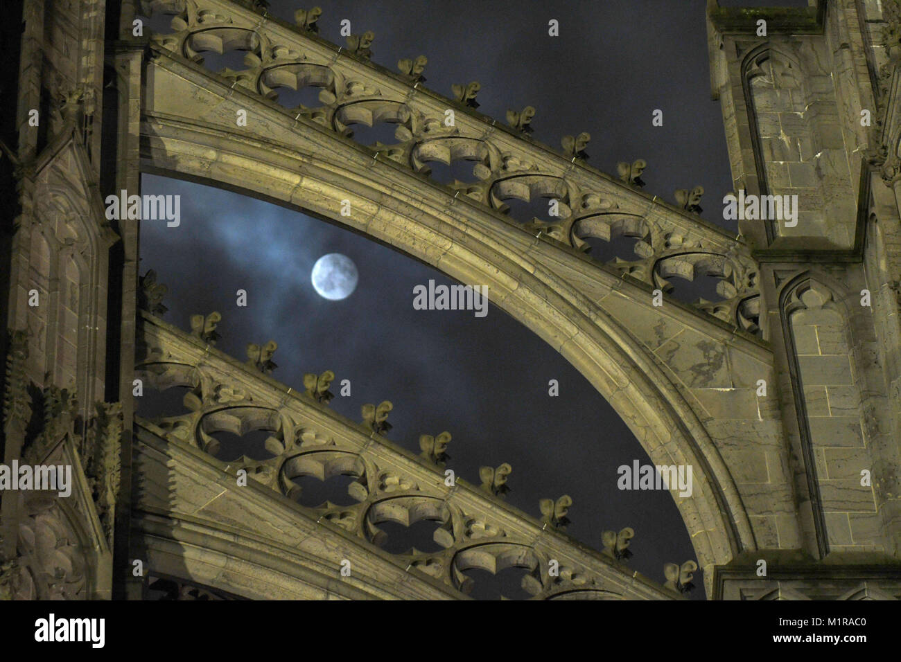 Cologne, Germany. 1st Feb, 2018. The full moon shines bright shortly after midnight, illuminating the Cathedral in Cologne, Germany, 1 February 2018. For the second time in a month the moon has shown its full face in the sky. It is especially close to earth and appears brighter and larger that usual. Credit: Henning Kaiser/dpa/Alamy Live News Stock Photo