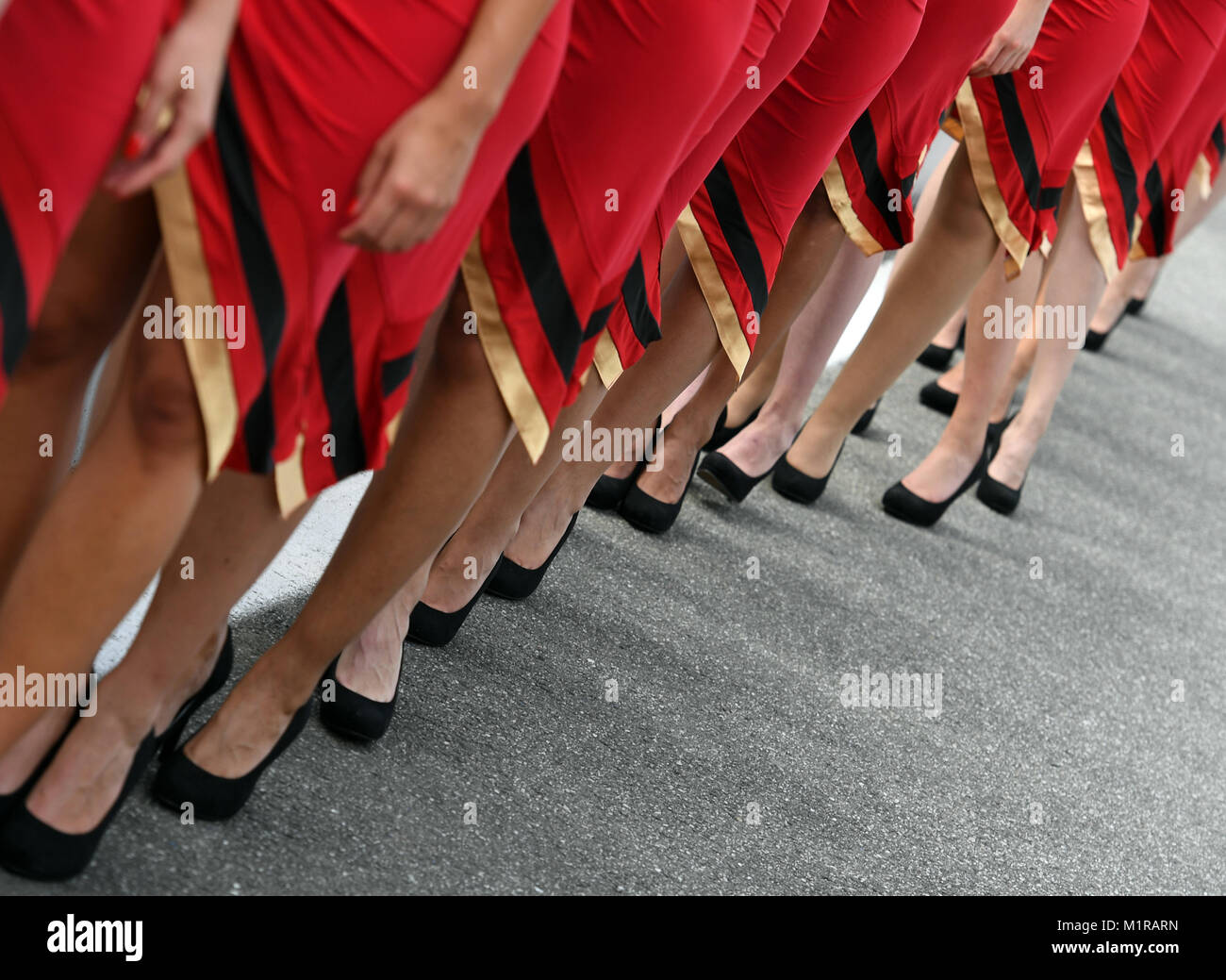 Hockenheim, Germany. 30th July, 2016. Grid Girls stand on the pit lane after the qualifier on the Hockenheimring in Hockenheim, Germany, 30 July 2016. The German Grand Prix takes place on 31 July 2016. Credit: ULI DECK/dpa | usage worldwide/dpa/Alamy Live News Stock Photo