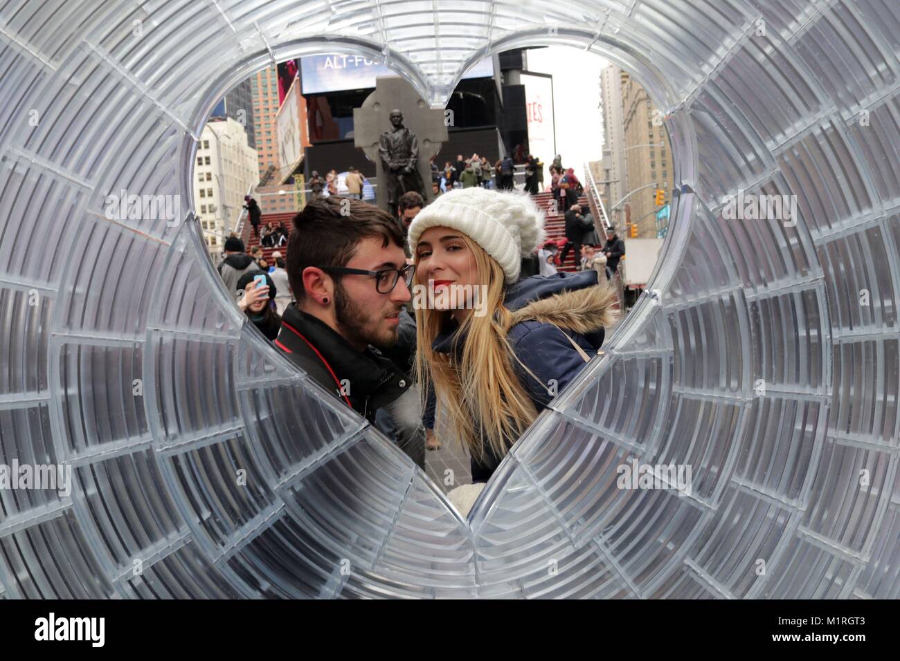 New York, New York, USA. 1st Feb, 2018. A couple about to kiss. Times Square Arts has unveiled the winner of the 10th anniversary Times Square Valentine Heart Design Competition, an annual event where Times Square Arts invites architecture and design firms to submit proposals for a public art installation celebrating Love in Times Square in February. Credit: 2018 G. Ronald Lopez/ZUMA Wire/Alamy Live News Stock Photo